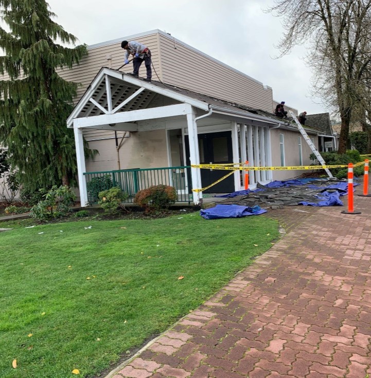 Professional roofers for Busy Boys Roofing LTD working on commercial building roof