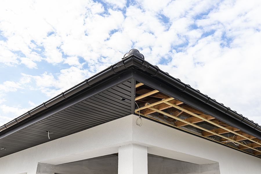 Soffit and Fascia being installed on a white house
